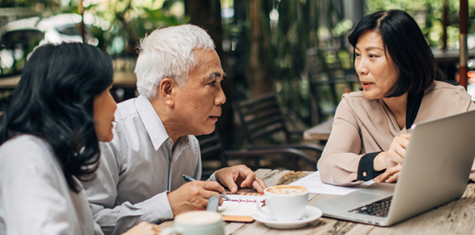 Family talking to a advisor on a coffeee